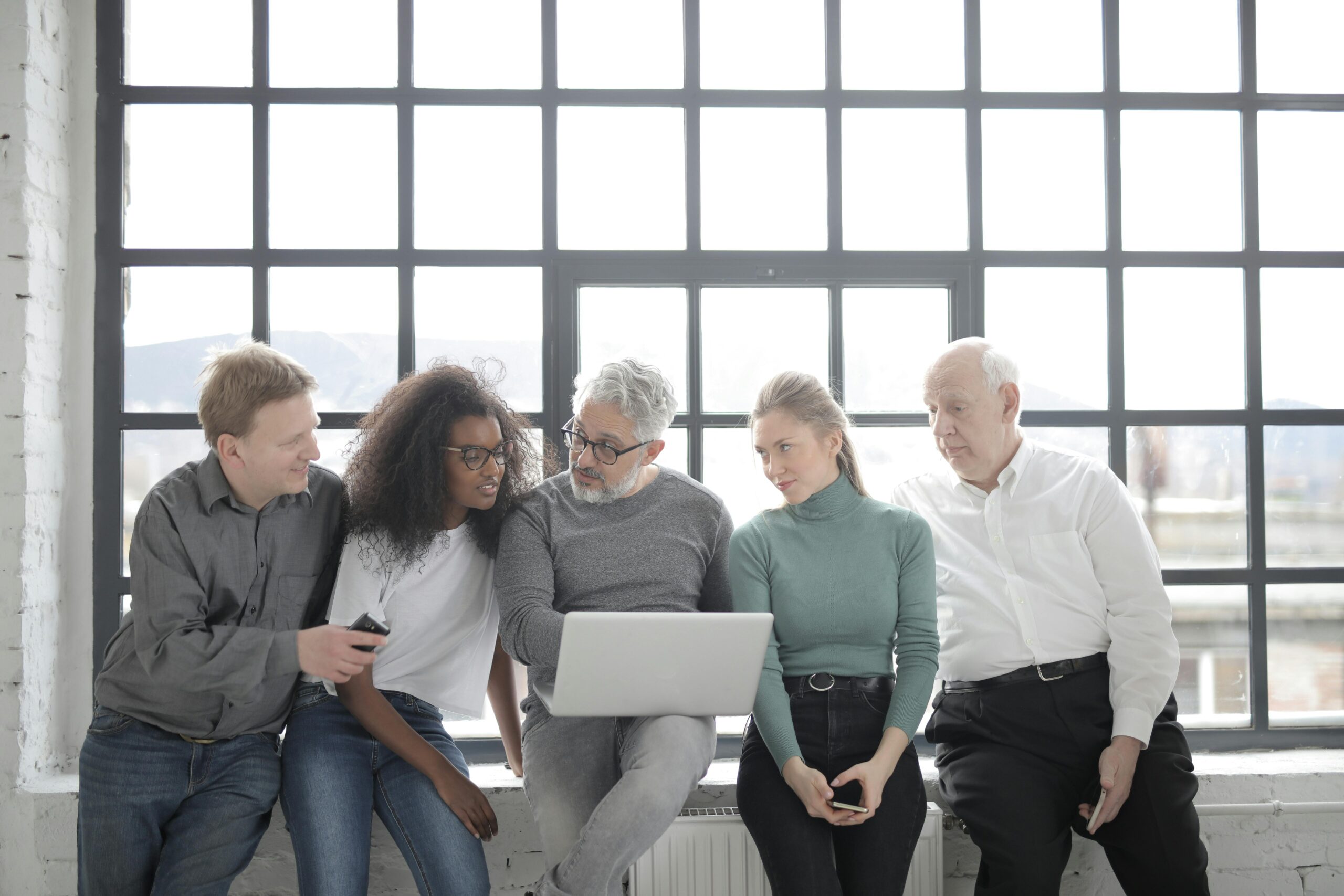 Multicultural team working together in a bright, modern office space.